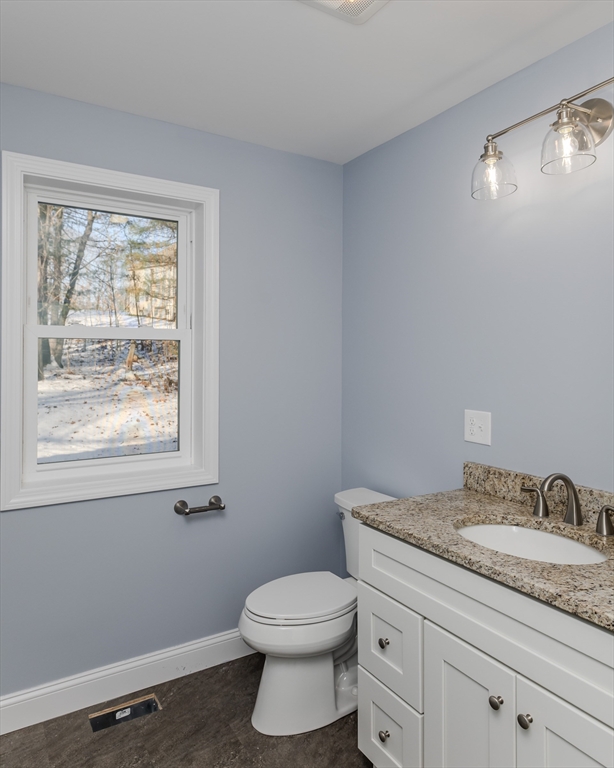 132 Kibbe Road East Longmeadow, MA 01028 - Photo 21 of 32 a bathroom with a granite countertop toilet a sink and a window