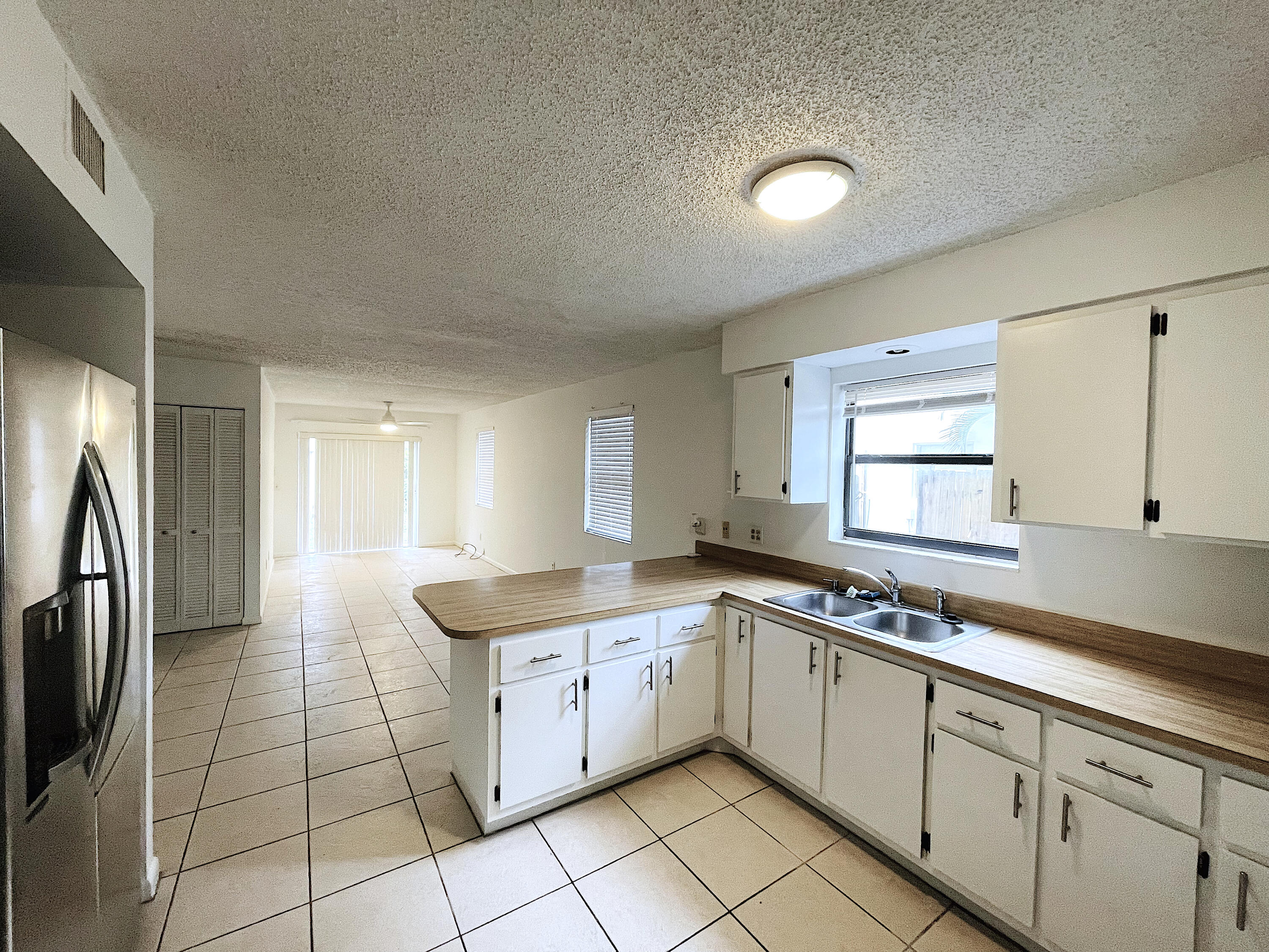 308 Hernando Street, Unit A Fort Pierce, FL 34949 - Photo 2 of 9 a kitchen with stainless steel appliances granite countertop a sink stove and refrigerator