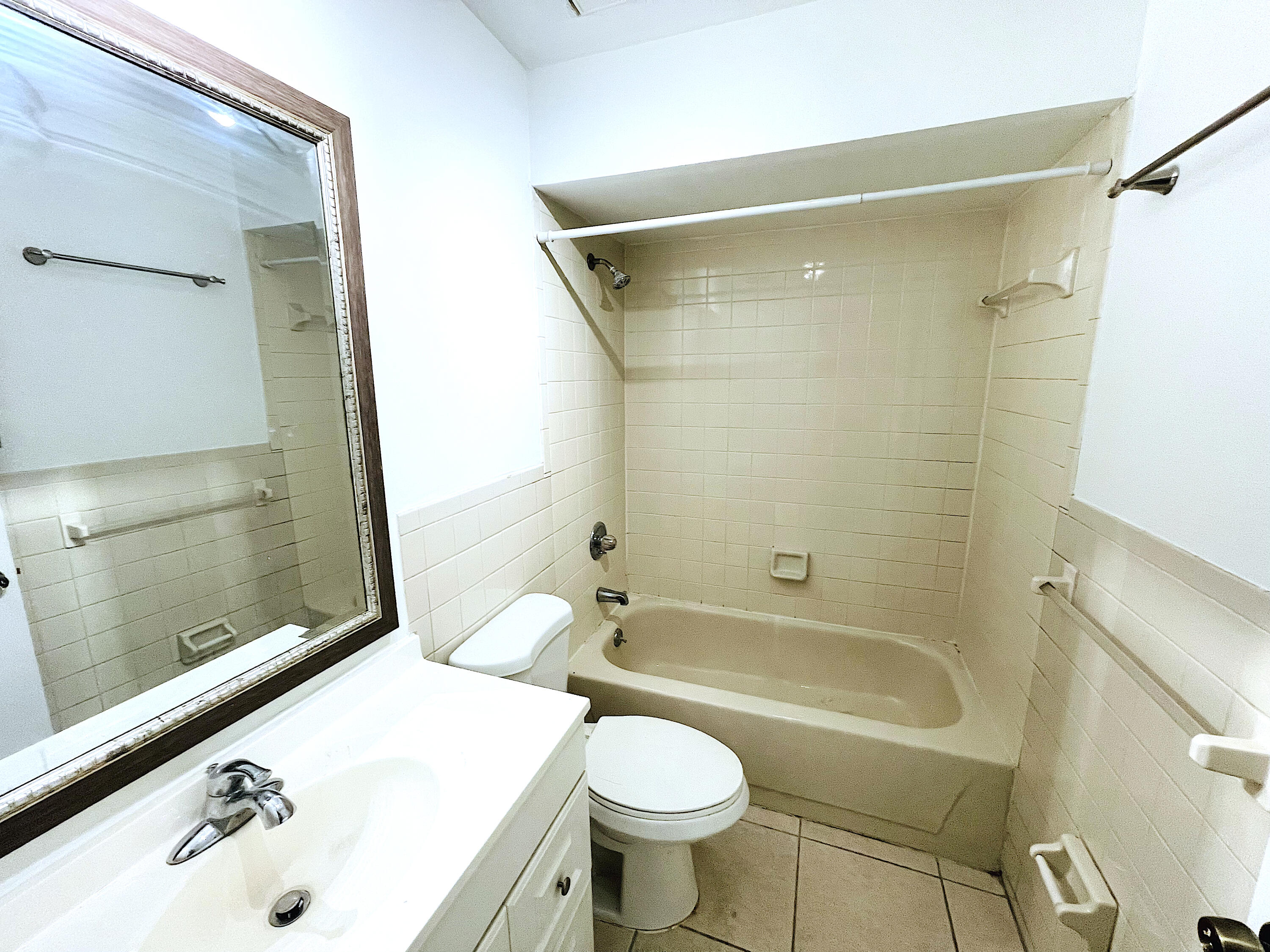 308 Hernando Street, Unit A Fort Pierce, FL 34949 - Photo 9 of 9 a bathroom with a sink toilet and shower