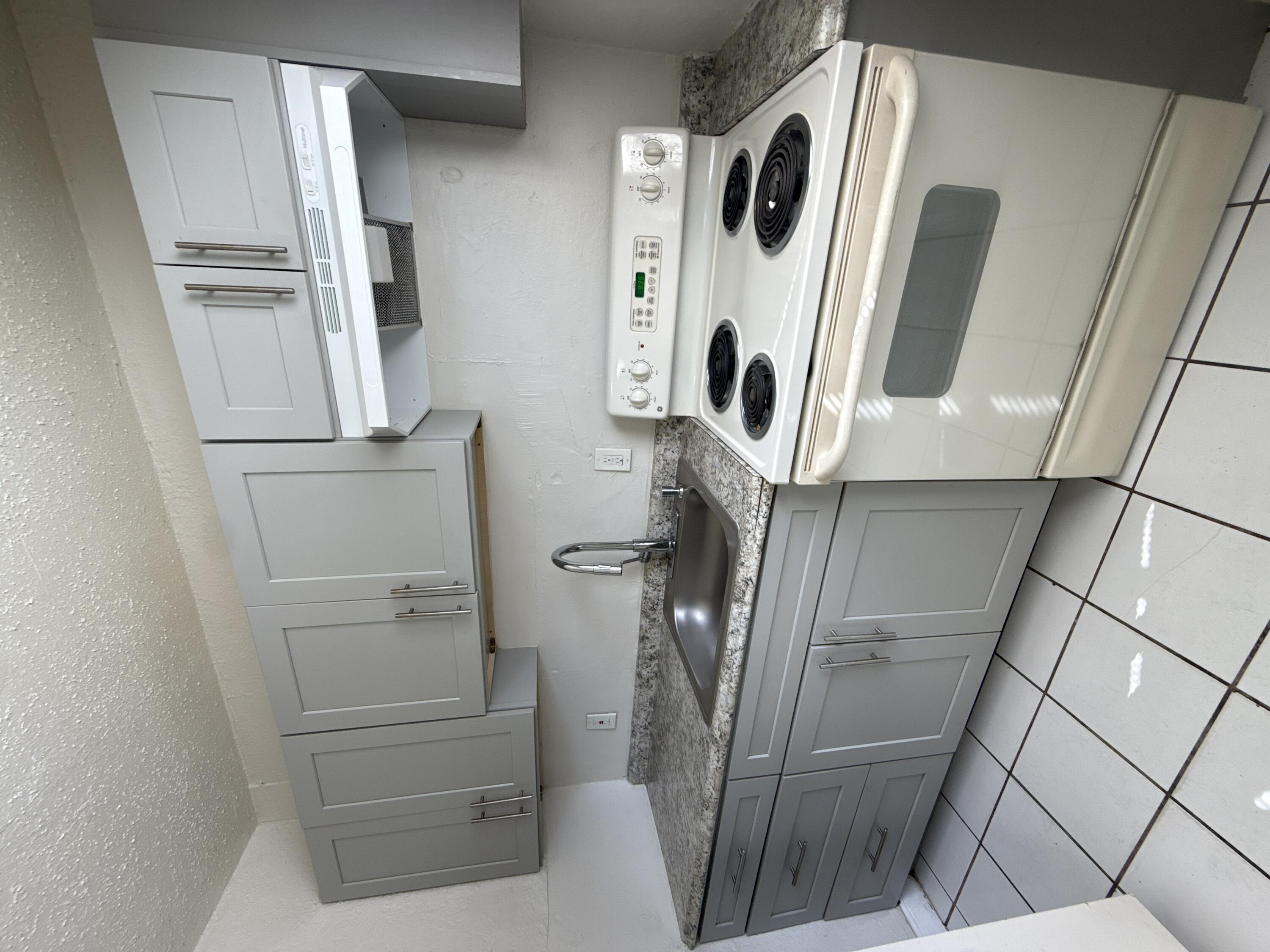 720 Southwest 7th Street, Unit 1 Dania Beach, FL 33004 - Photo 3 of 4 a bathroom with a shower and a mirror
