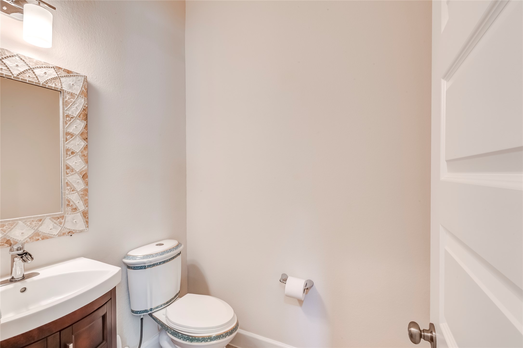 345 Fort Cobb Way Georgetown, TX 78628 - Photo 18 of 38 A compact powder room contains a dark wood vanity and a neutral wall color palette.