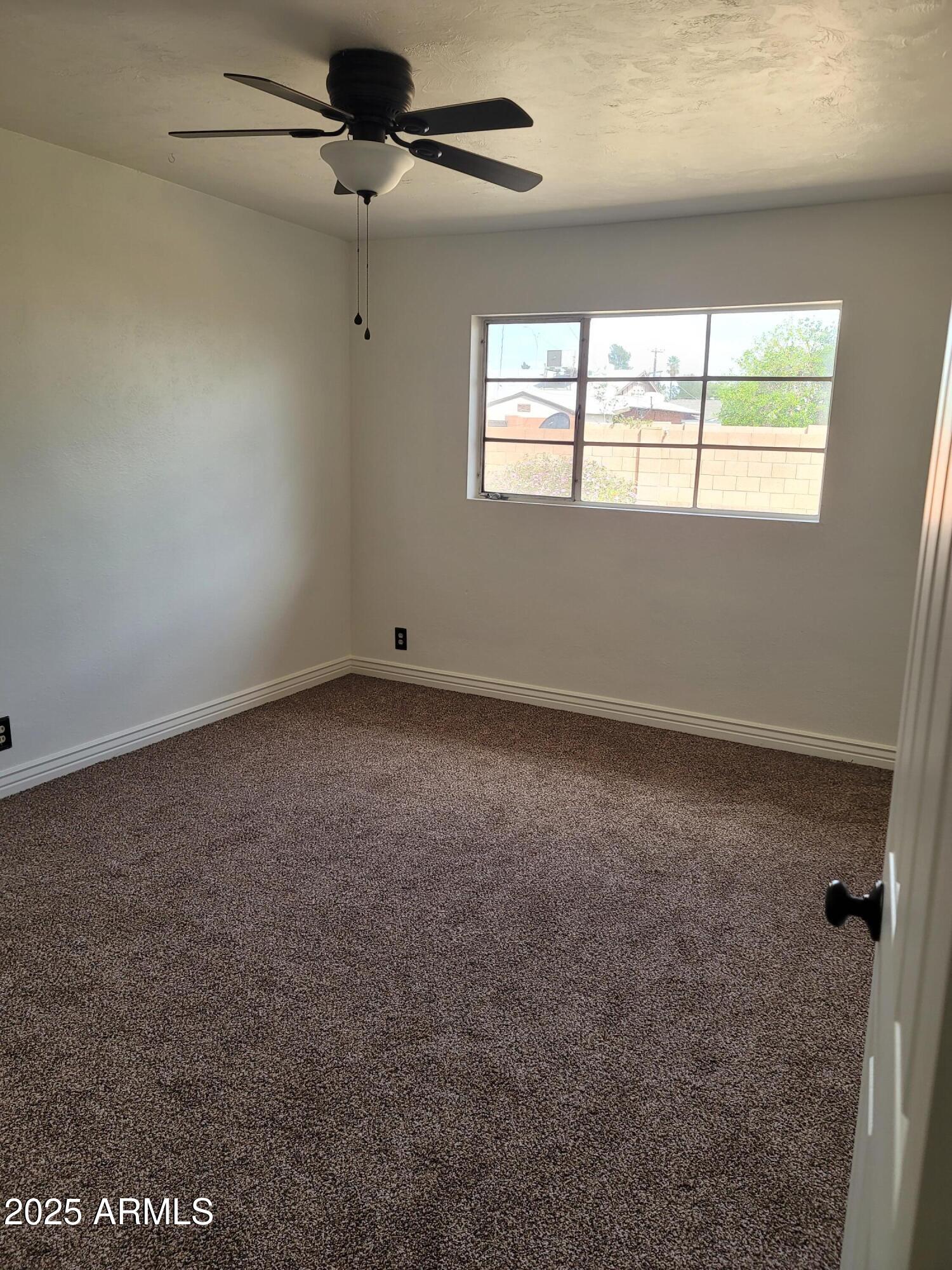 3926 West McLellan Boulevard Phoenix, AZ 85019 - Photo 11 of 14 an empty room with windows