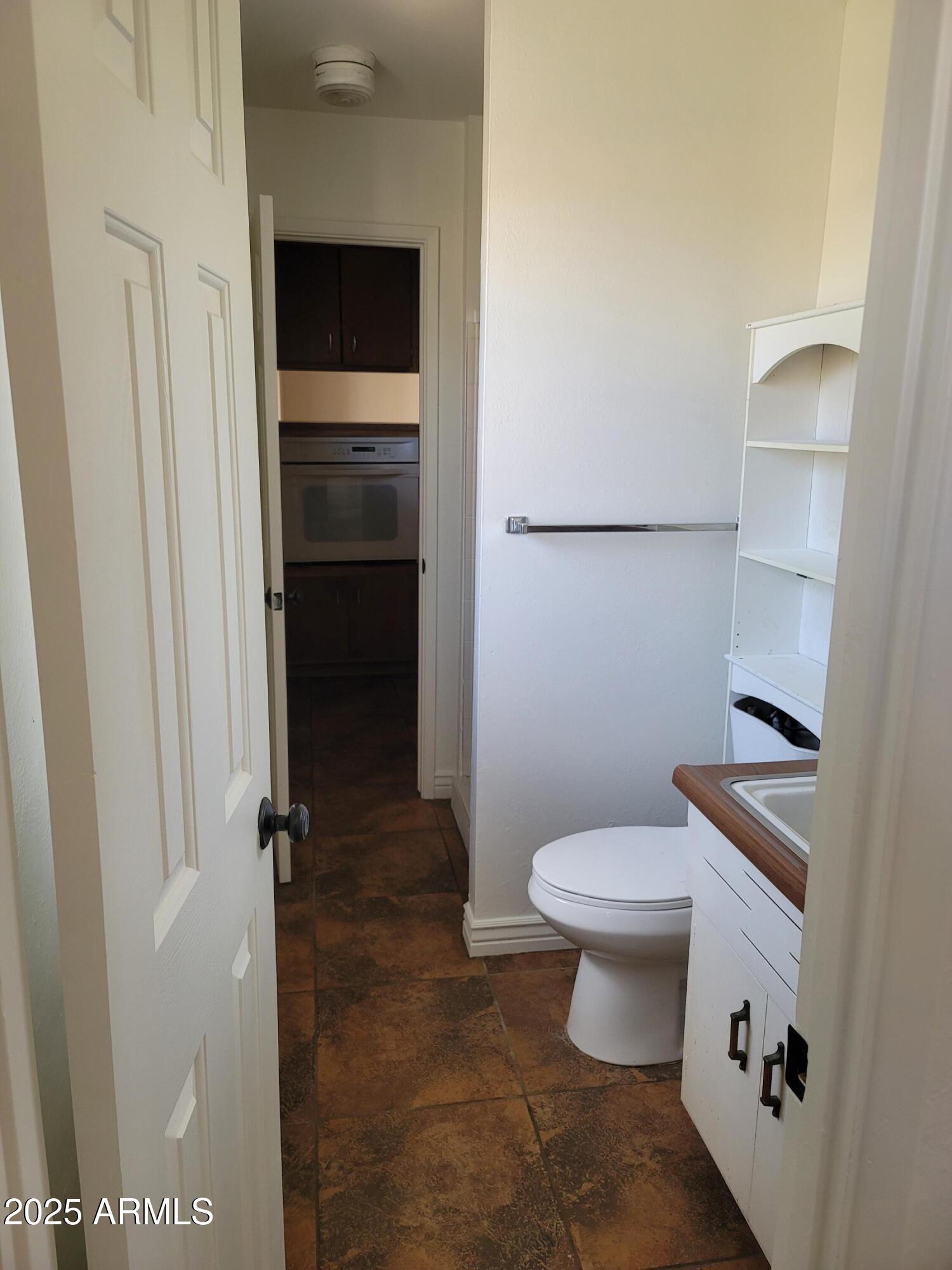 3926 West McLellan Boulevard Phoenix, AZ 85019 - Photo 14 of 14 a bathroom with a toilet and a shower