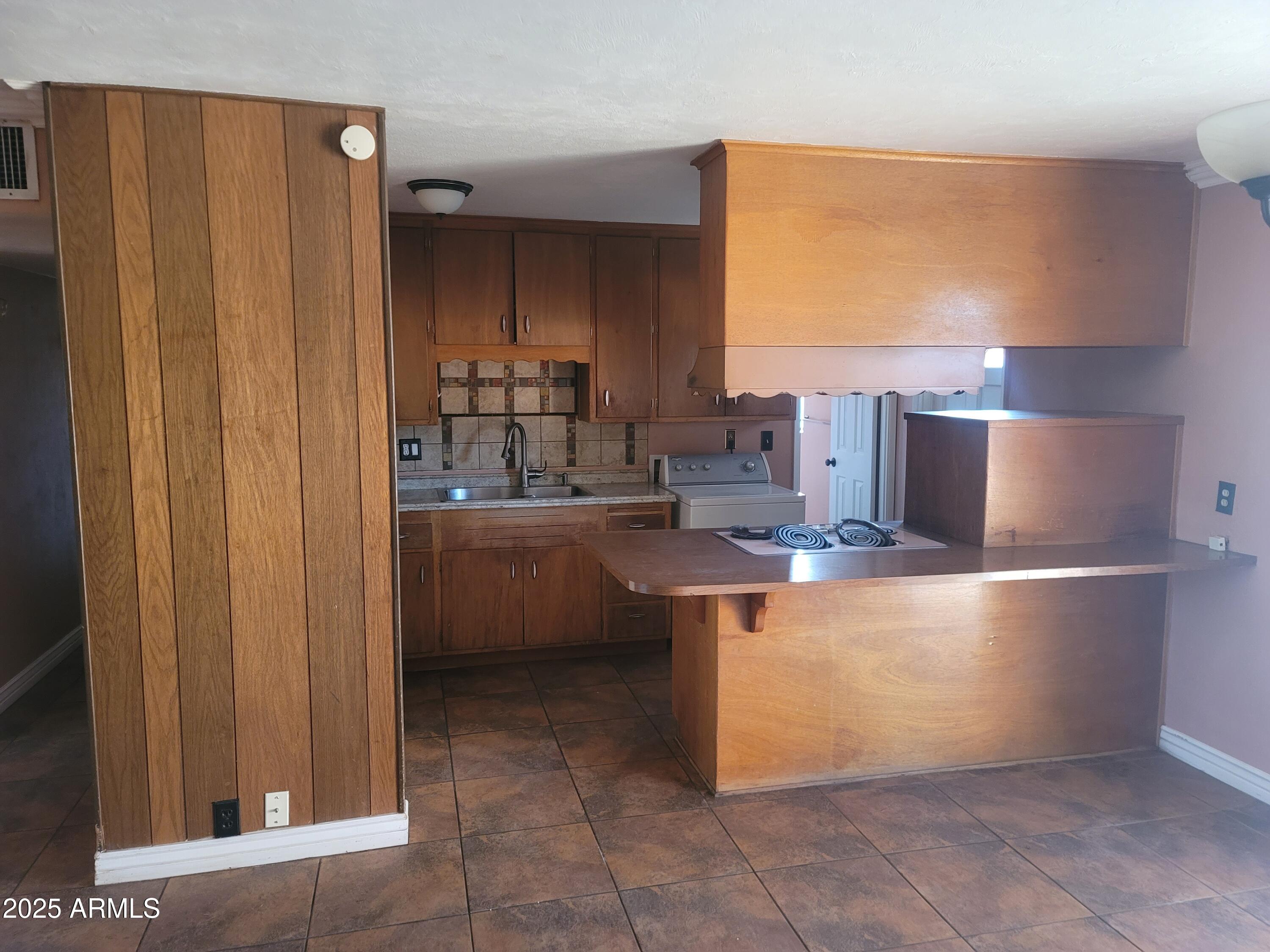 3926 West McLellan Boulevard Phoenix, AZ 85019 - Photo 5 of 14 a kitchen with a sink and cabinets