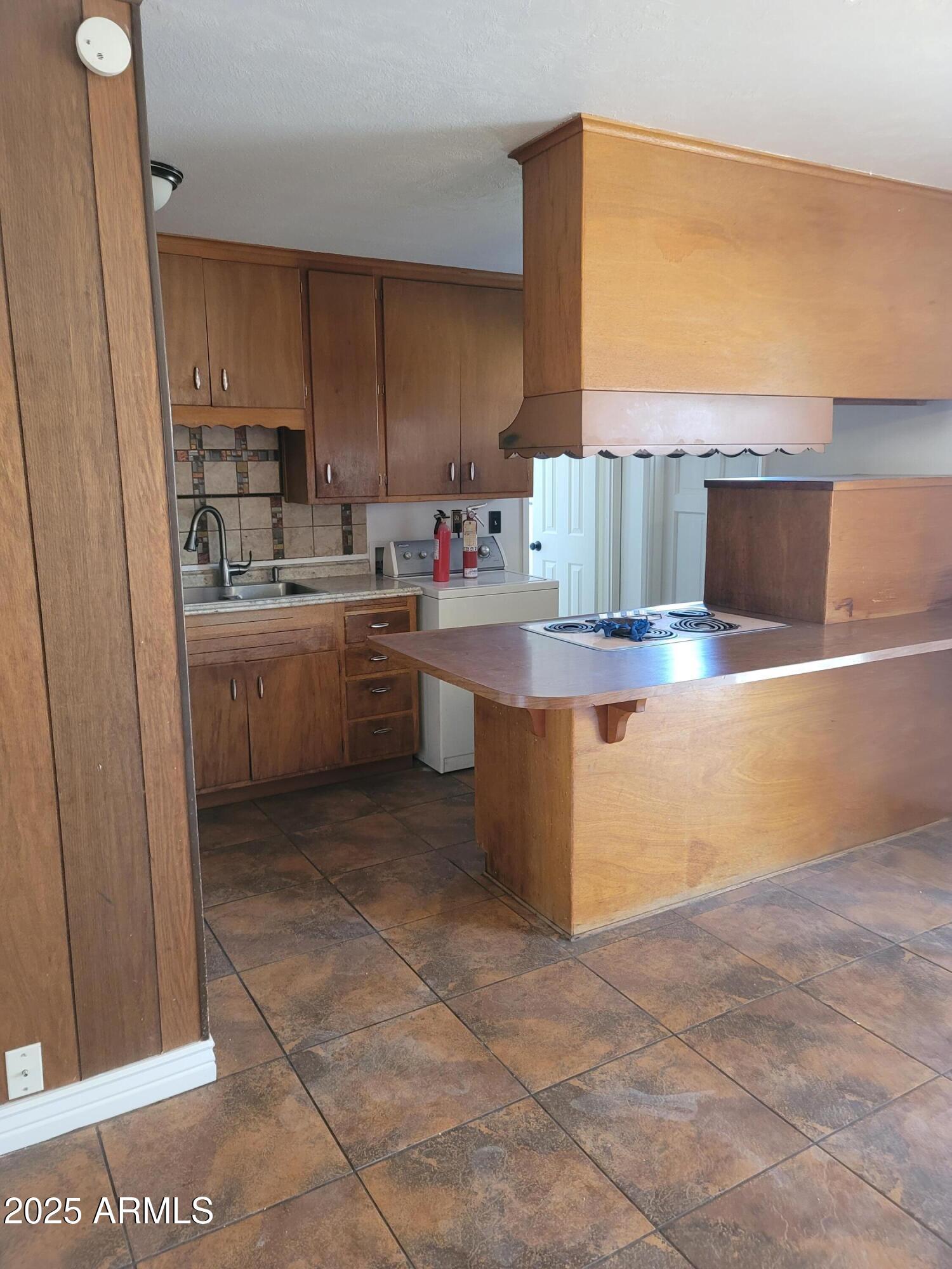 3926 West McLellan Boulevard Phoenix, AZ 85019 - Photo 7 of 14 a kitchen with stainless steel appliances granite countertop a sink and a stove