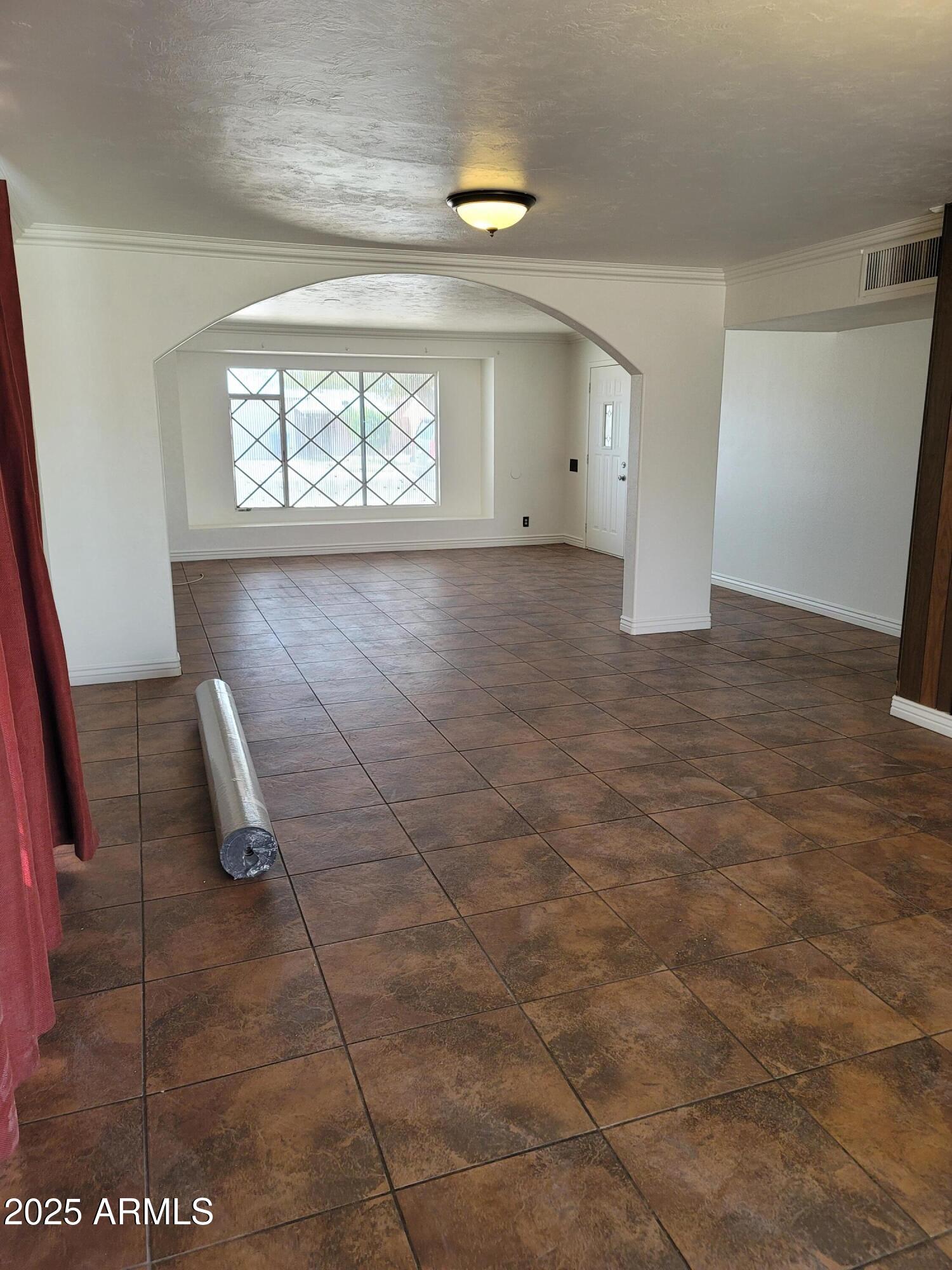 3926 West McLellan Boulevard Phoenix, AZ 85019 - Photo 8 of 14 an empty room with windows