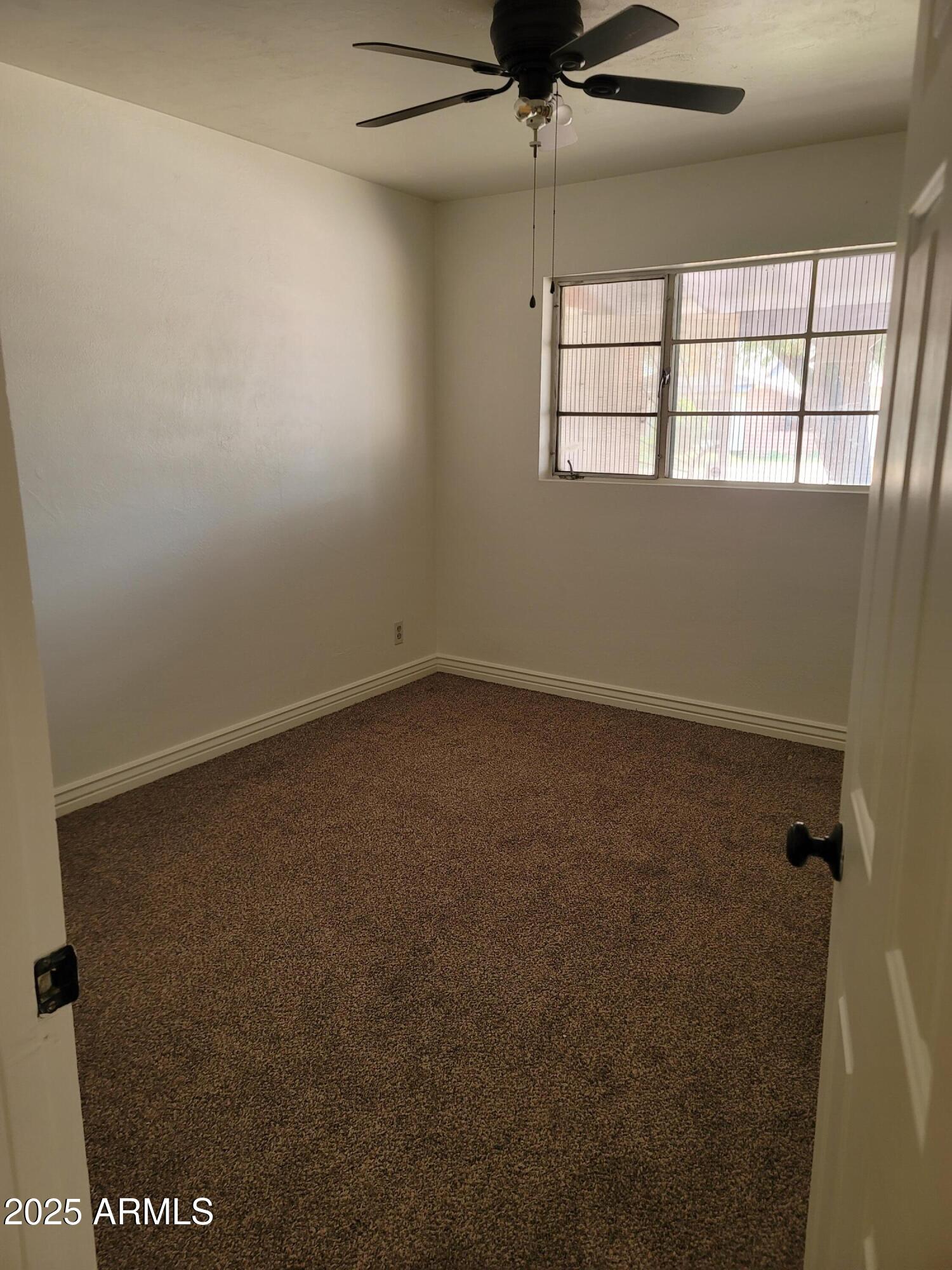 3926 West McLellan Boulevard Phoenix, AZ 85019 - Photo 9 of 14 an empty room with a window