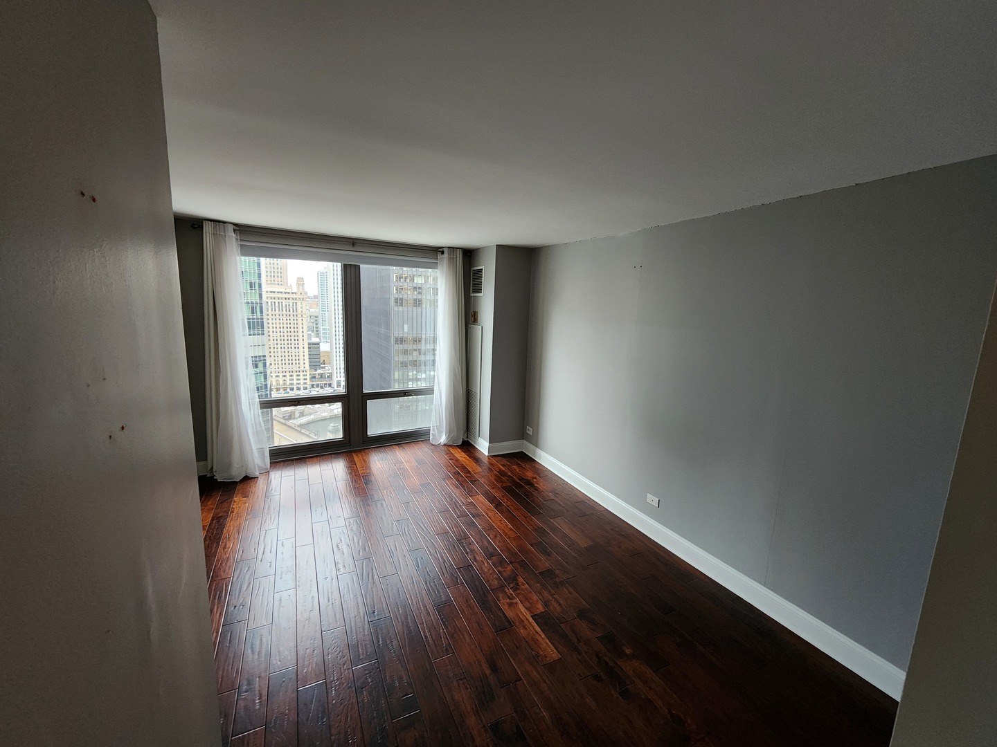 440 North Wabash Avenue, Unit 3109 Chicago, IL 60611 - Photo 4 of 25 wooden floor in an empty room with a window