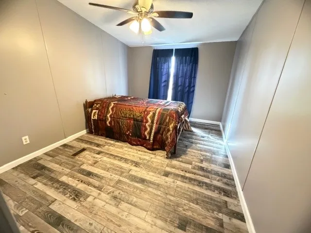 a bedroom with a bed and painting on the wall