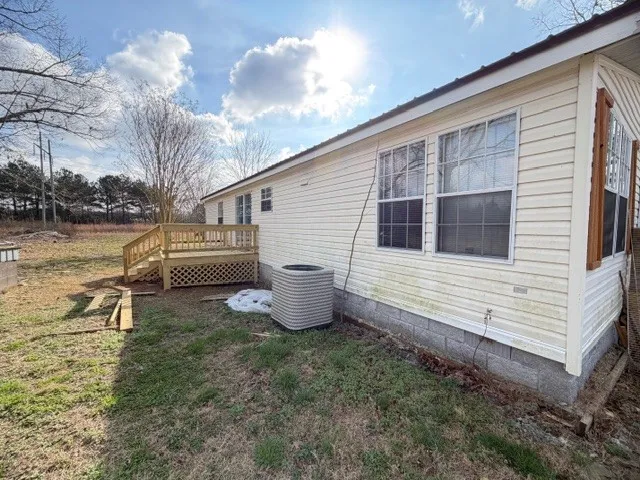 a backyard of a house with lots of green space and fountain
