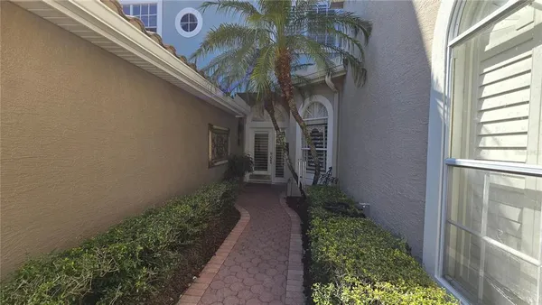 a view of a pathway of a house with garden