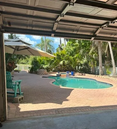 a view of a swimming pool with a yard