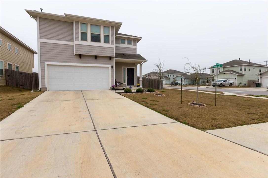 148 Triumph Road Buda, TX 78610 - Photo 1 of 1 a backyard of a house with yard and garage
