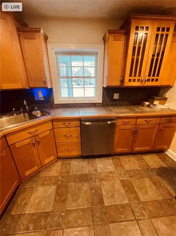 a kitchen with stainless steel appliances granite countertop a sink and a cabinets