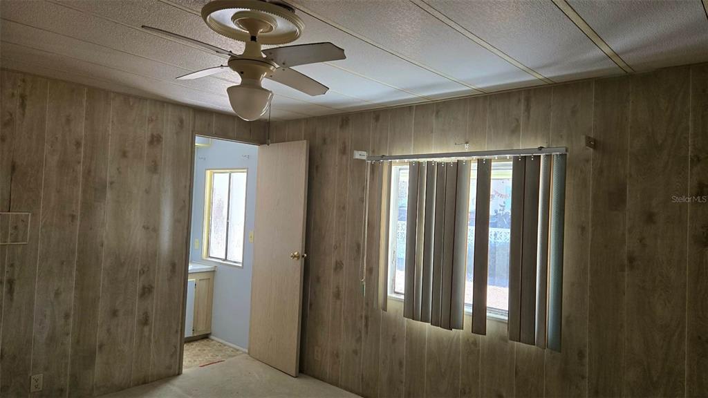 5921 Southwest 63rd Street Ocala, FL 34474 - Photo 14 of 24 a view of a livingroom with a chandelier fan and windows