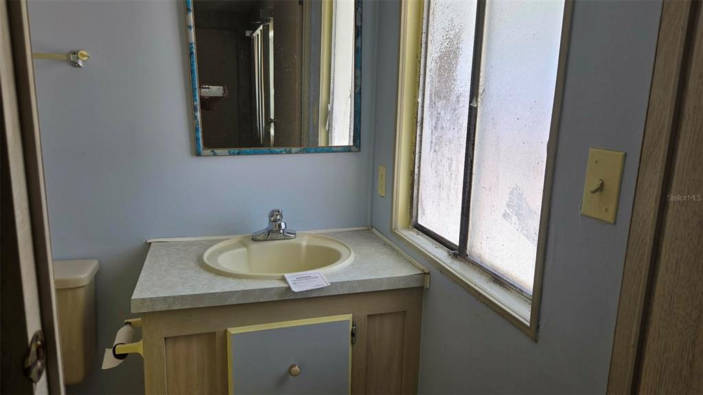 5921 Southwest 63rd Street Ocala, FL 34474 - Photo 16 of 24 a bathroom with a granite countertop sink and a mirror