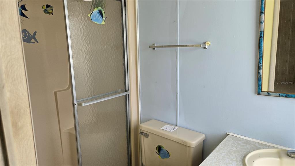 5921 Southwest 63rd Street Ocala, FL 34474 - Photo 17 of 24 a bathroom with a toilet and a shower