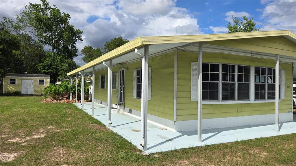 5921 Southwest 63rd Street Ocala, FL 34474 - Photo 2 of 24 a view of a house with a backyard