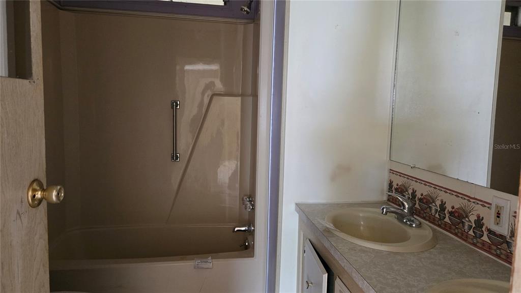 5921 Southwest 63rd Street Ocala, FL 34474 - Photo 23 of 24 a bathroom with a sink and shower