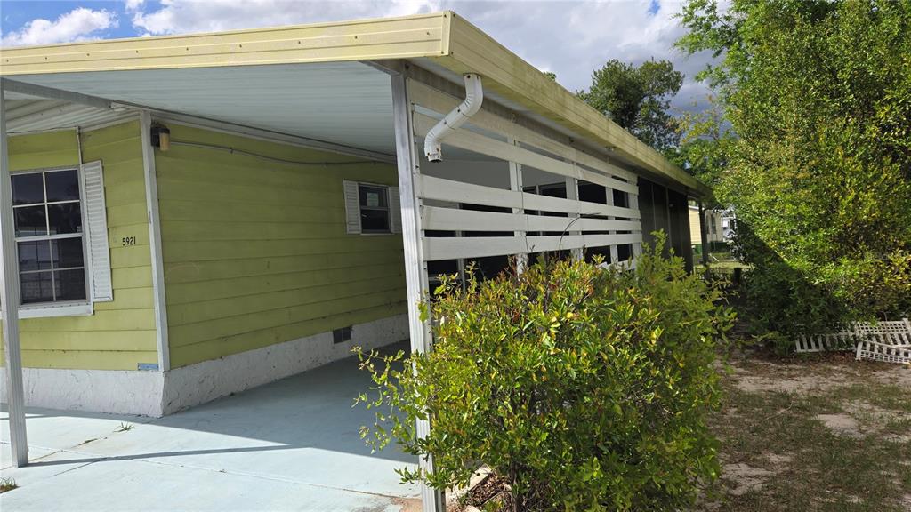 5921 Southwest 63rd Street Ocala, FL 34474 - Photo 4 of 24 a house with a small yard