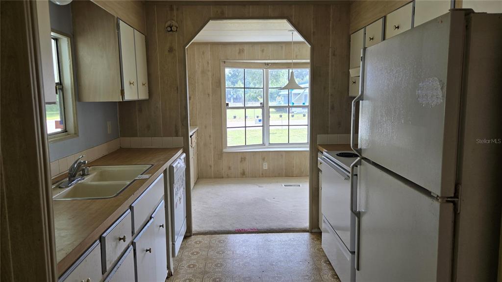 5921 Southwest 63rd Street Ocala, FL 34474 - Photo 7 of 24 a kitchen that has a sink and a stove