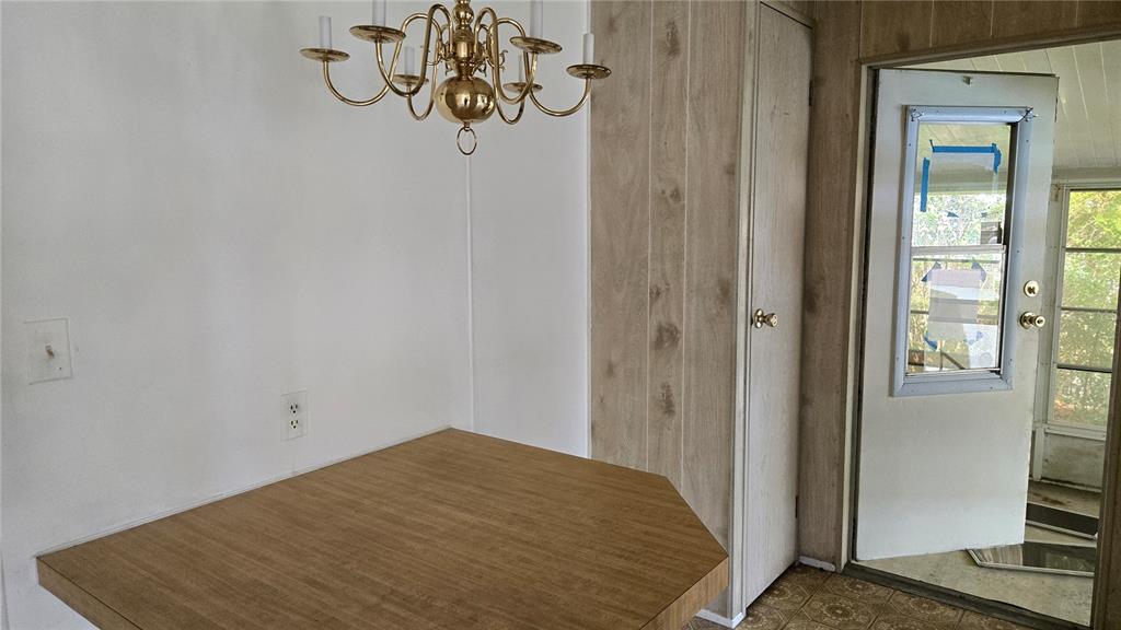 5921 Southwest 63rd Street Ocala, FL 34474 - Photo 9 of 24 a bedroom with a bed and chandelier