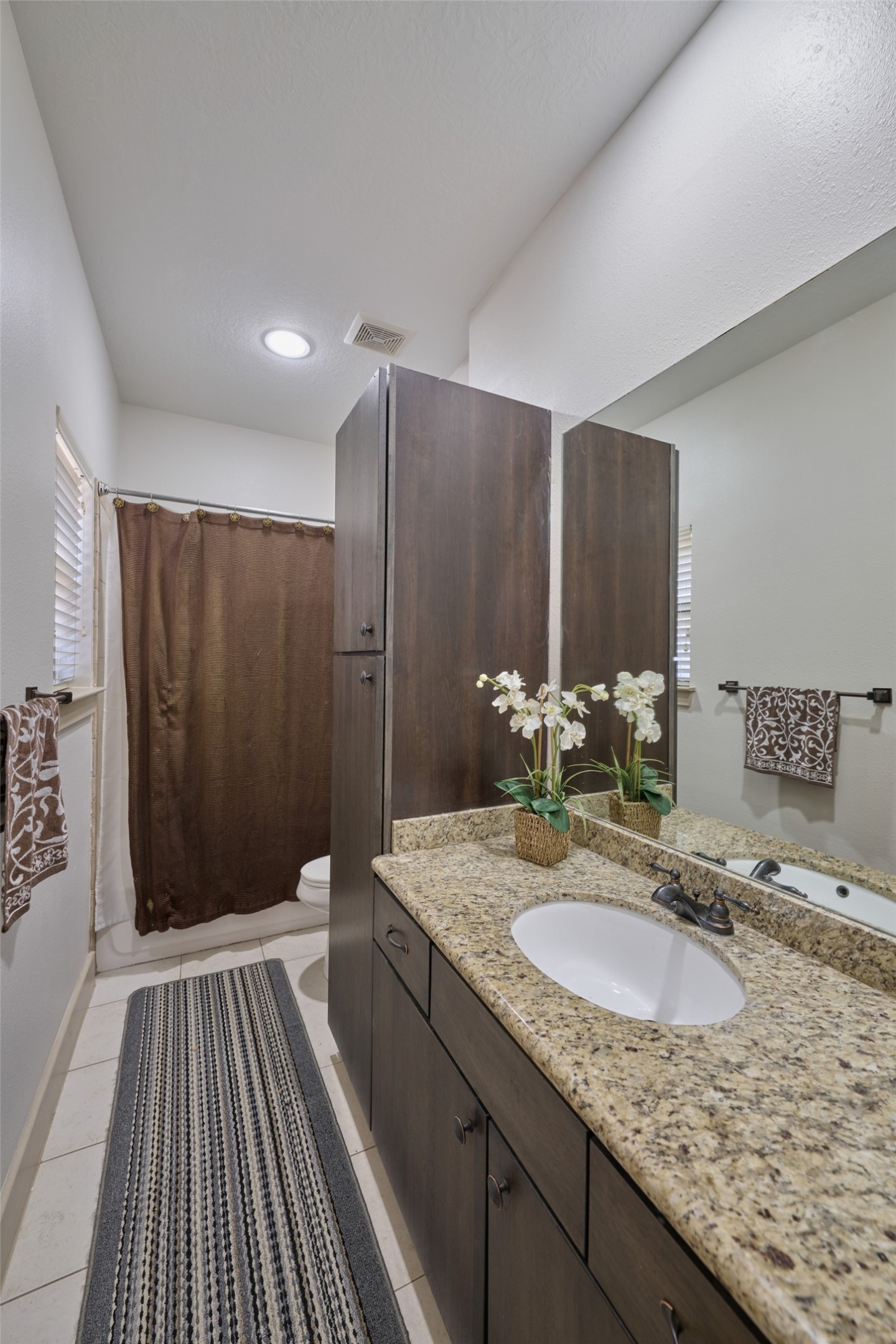 2422 Navigation Boulevard, Unit E Houston, TX 77003 - Photo 27 of 29 a bathroom with a granite countertop sink and a mirror