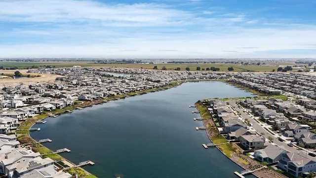 a front view of a house with a garden and plants