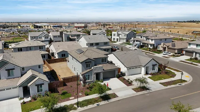 an aerial view of residential building with parking