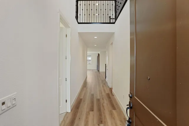 a view of an entryway with wooden floor and stairs