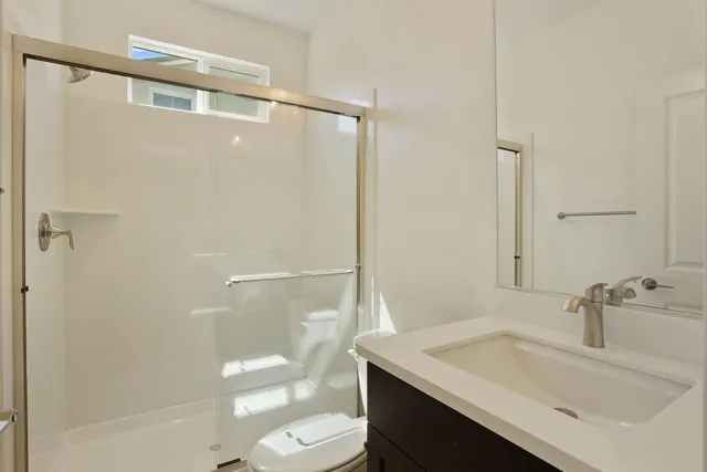 a kitchen with stainless steel appliances a sink a stove a refrigerator and island