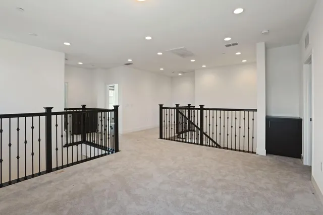 a view of an empty room with a fireplace and a window