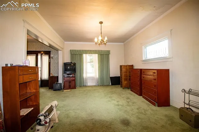 a view of a livingroom with workspace and a window