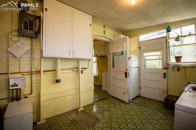 a view of an empty room with closet and a window