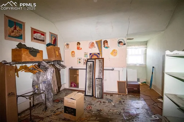 a view of a livingroom with a piano and wooden floor