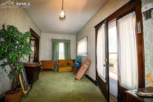 a living room with furniture a flat screen tv and a window