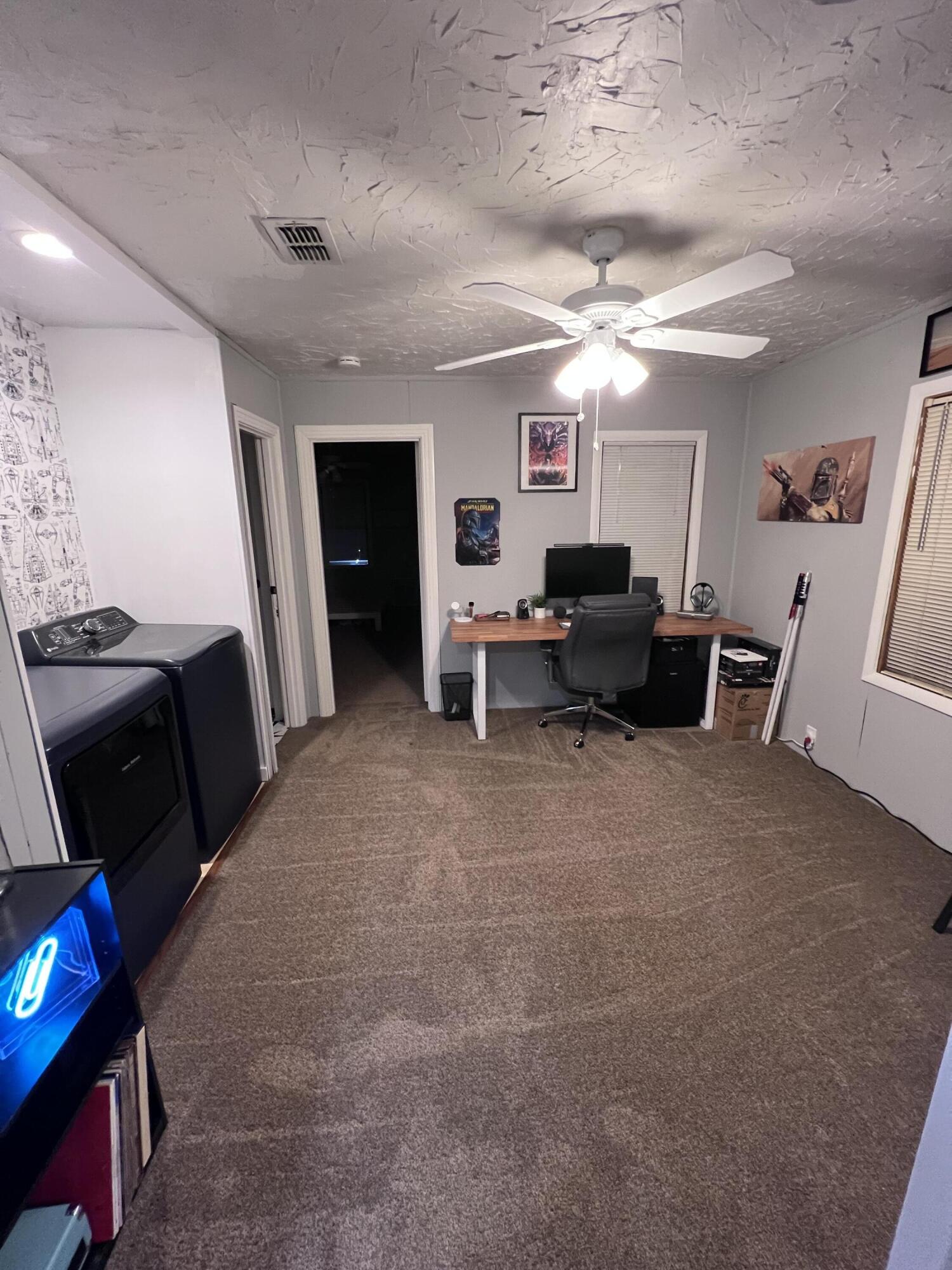 502 Main Street Anton, TX 79313 - Photo 12 of 16 a living room with furniture and a flat screen tv