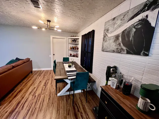 a bedroom with a bed and a flat tv screen on a dresser