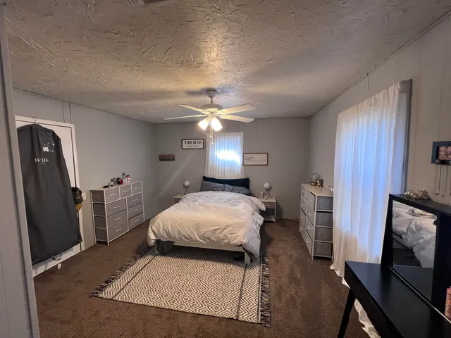 a view of a livingroom with furniture and a flat screen tv