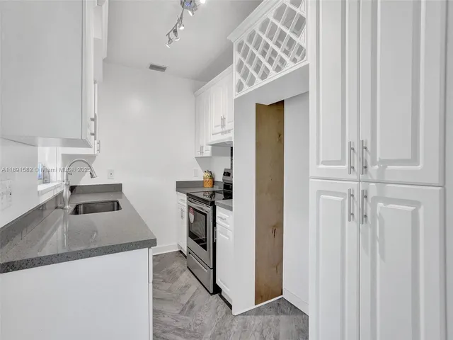 a kitchen that has a sink and a stove