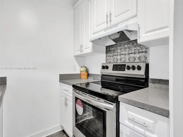 a stove top oven sitting inside of a kitchen