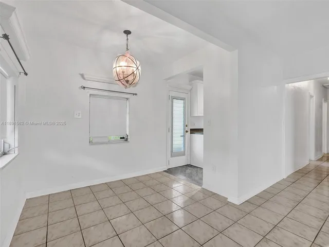 a view of a hallway to rooms