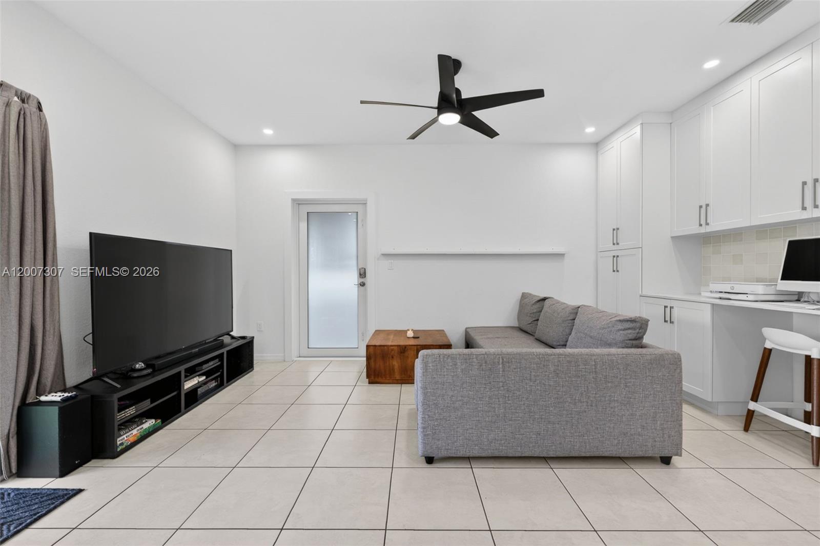 12310 Southwest 216th Street Miami, FL 33170 - Photo 11 of 22 a living room with furniture and a flat screen tv