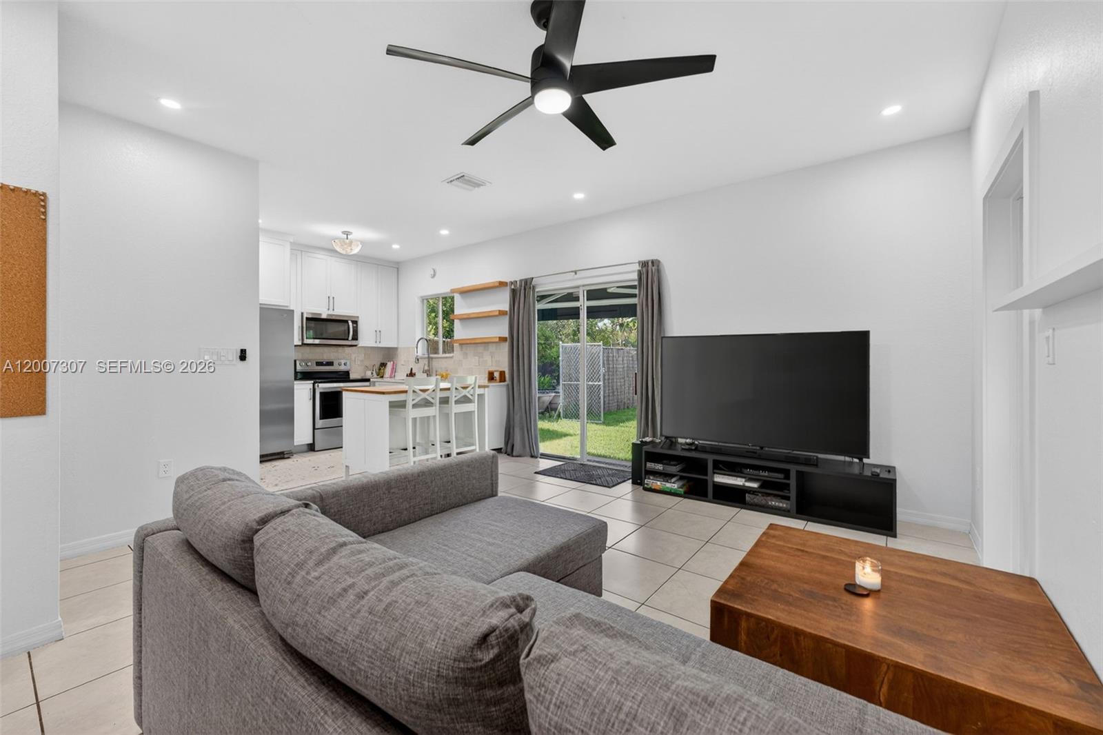 12310 Southwest 216th Street Miami, FL 33170 - Photo 12 of 22 a living room with furniture and a flat screen tv