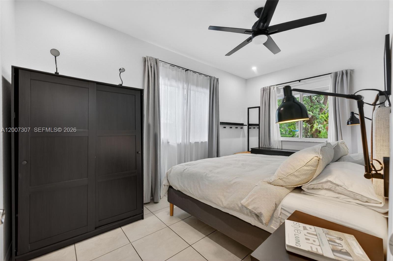 12310 Southwest 216th Street Miami, FL 33170 - Photo 13 of 22 a bedroom with a bed closet and a window