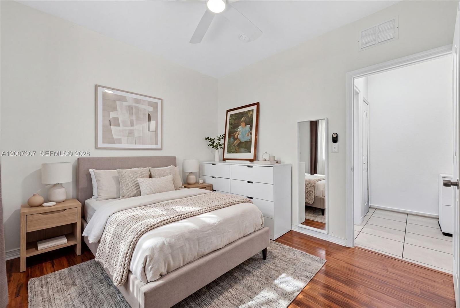 12310 Southwest 216th Street Miami, FL 33170 - Photo 14 of 22 a bedroom with a bed and a painting on the wall