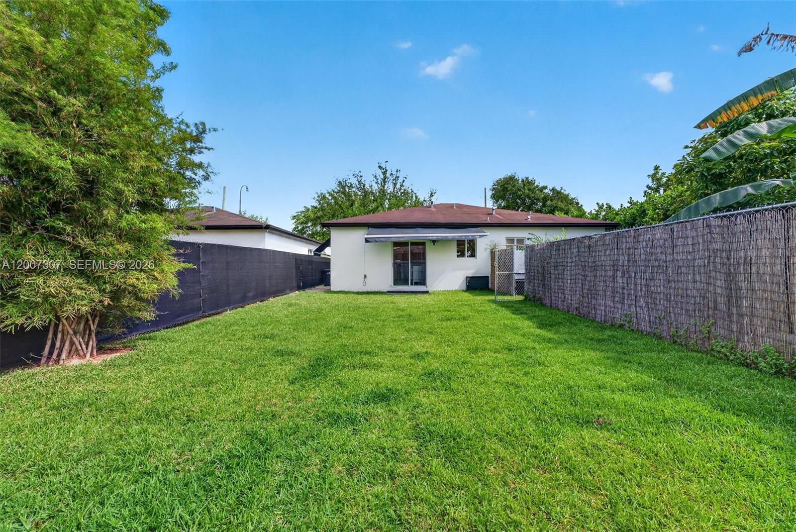 12310 Southwest 216th Street Miami, FL 33170 - Photo 19 of 22 a front view of a house with a yard