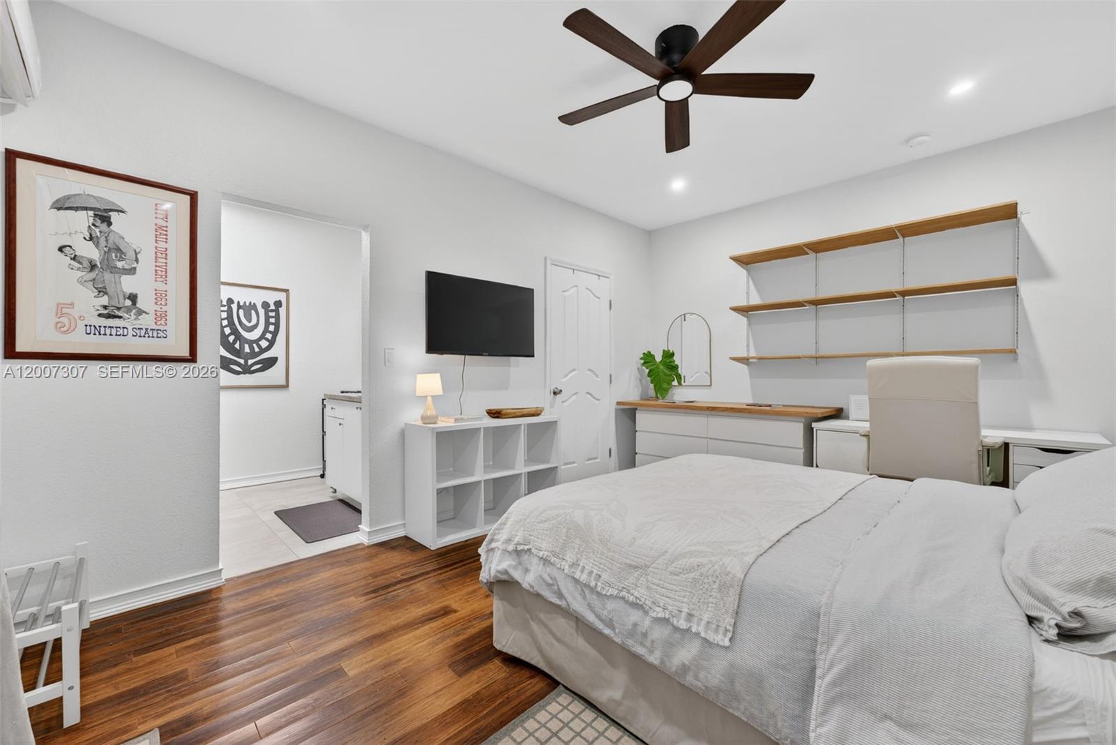 12310 Southwest 216th Street Miami, FL 33170 - Photo 21 of 22 a bedroom with a bed and a flat screen tv
