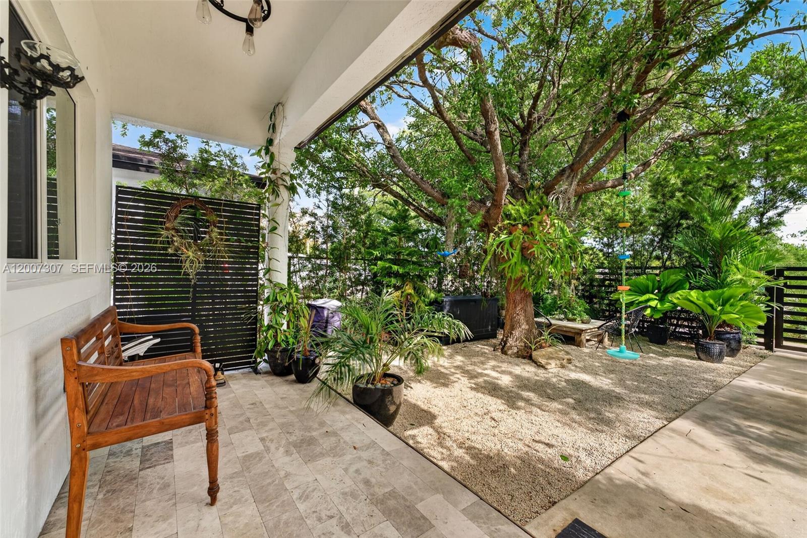 12310 Southwest 216th Street Miami, FL 33170 - Photo 4 of 22 a backyard of a house with table and chairs