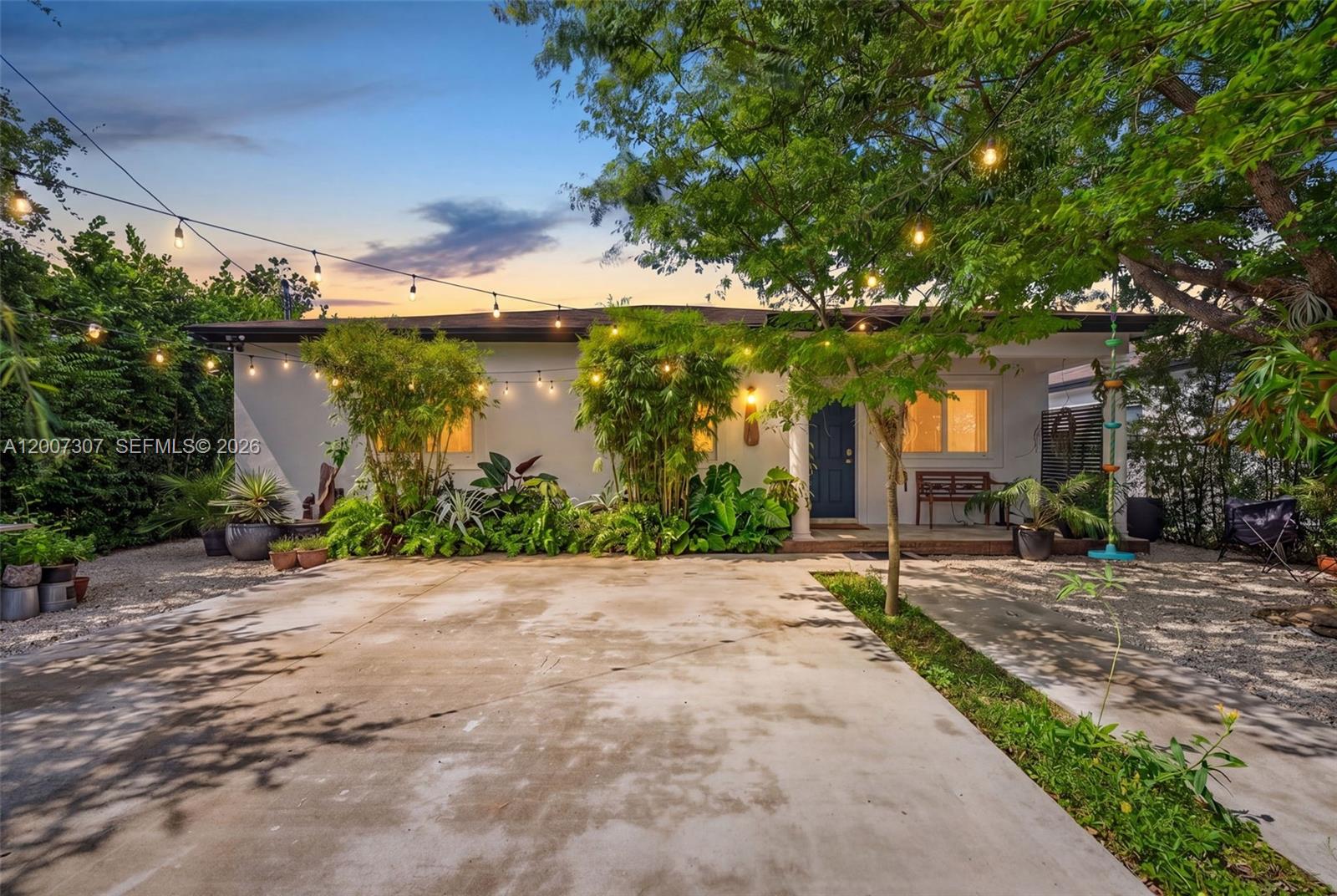 12310 Southwest 216th Street Miami, FL 33170 - Photo 5 of 22 a view of a patio with table and chairs under an umbrella